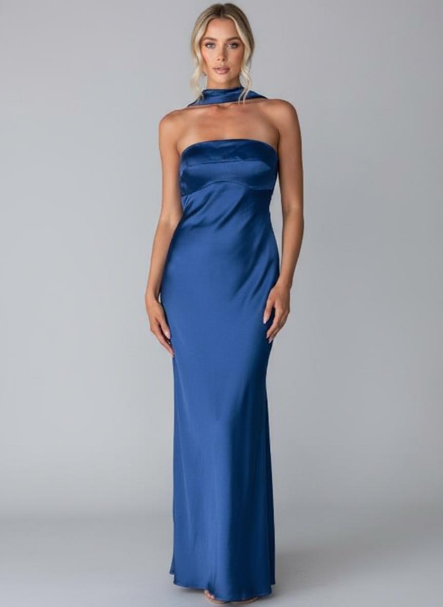 Woman wearing a blue strapless gown on a gray background