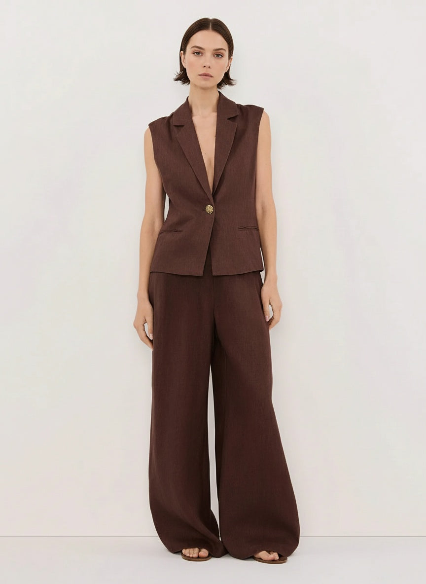 Woman wearing a brown suit with a white background