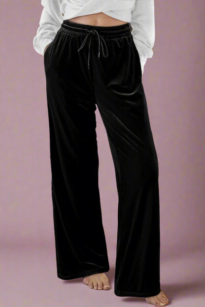 Black wide-leg pants worn by a person .