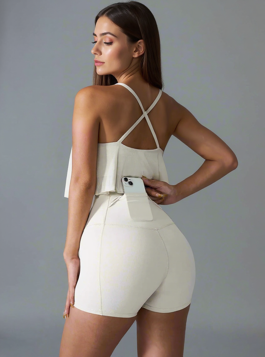 Woman wearing a white romper with a gray background