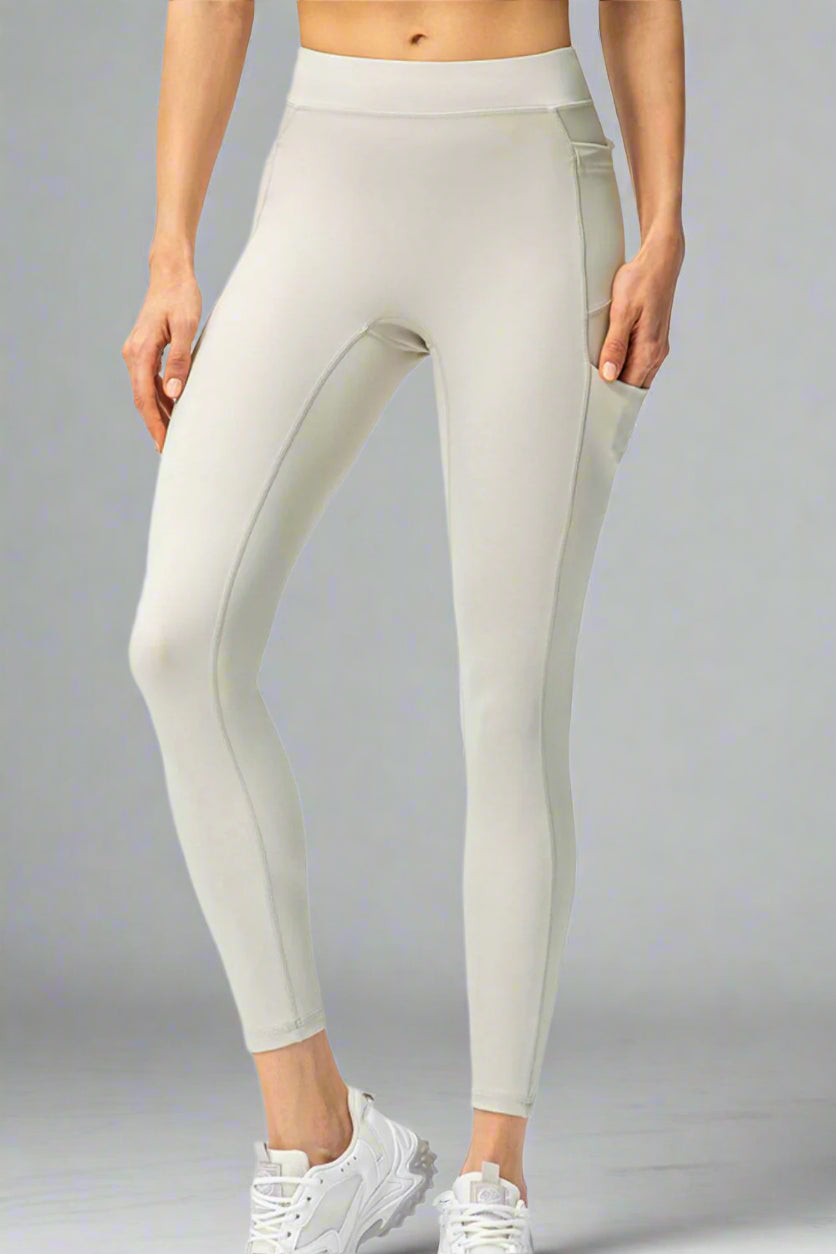 White leggings worn by a person on a white background