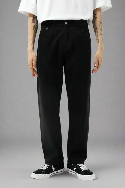 Person wearing black pants and a white shirt on a white background