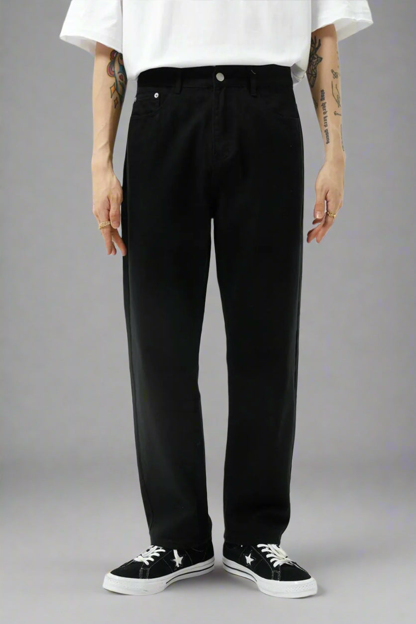 Person wearing black pants and a white shirt on a white background