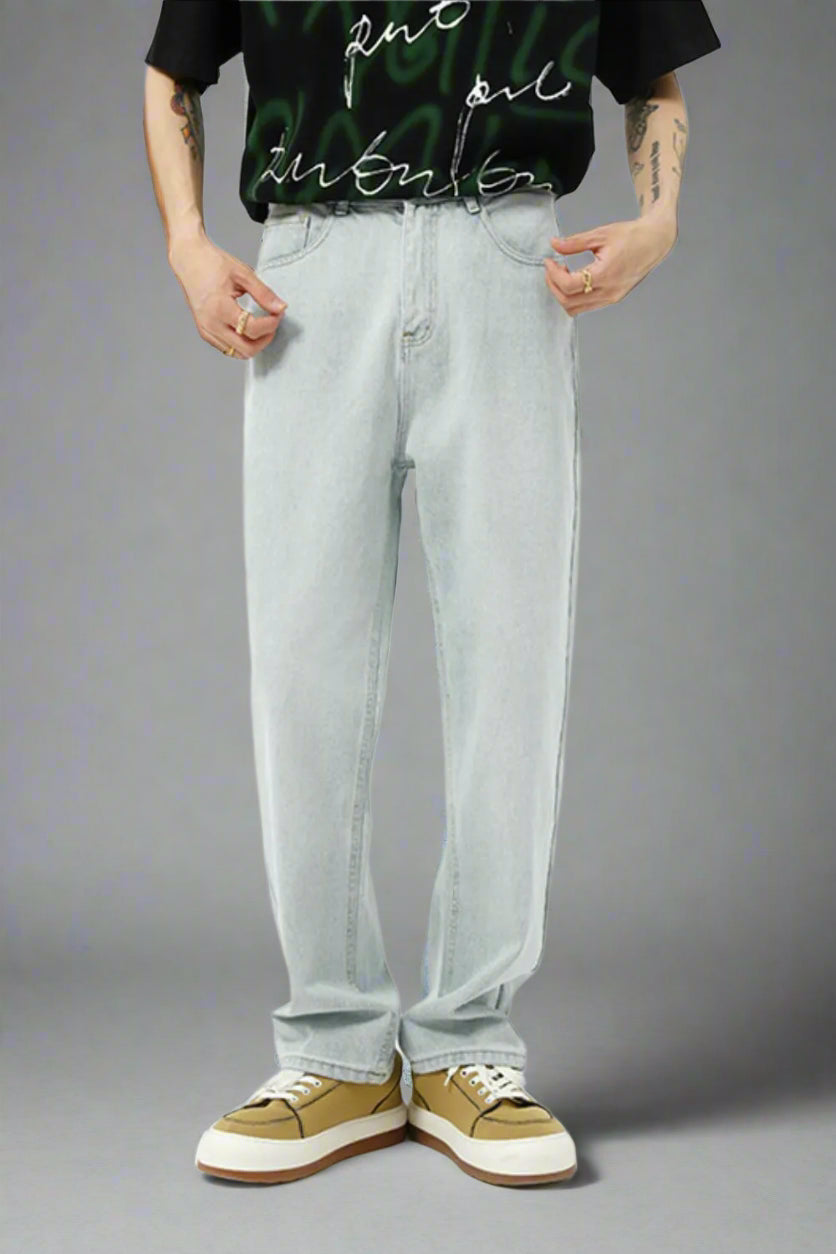 Person wearing light blue jeans and a black t-shirt with white text on a white background