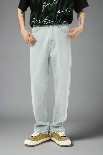 Person wearing light blue jeans and a black t-shirt with white text on a white background