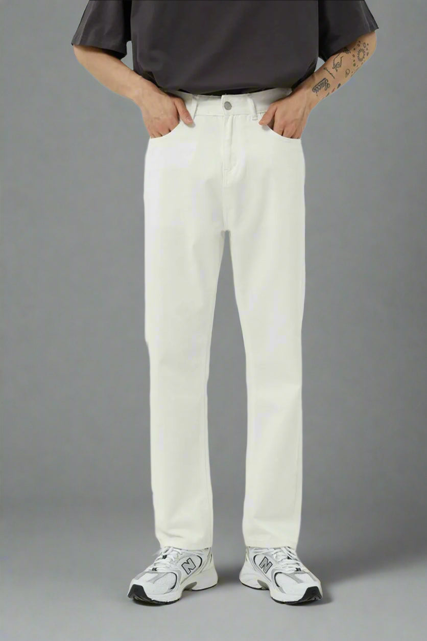 Person wearing a black shirt, white pants, and white sneakers on a light gray background