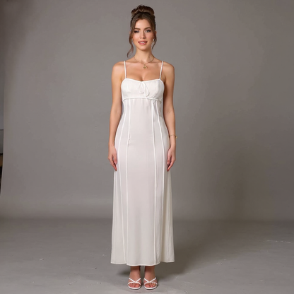 Woman wearing a white dress against a gray background