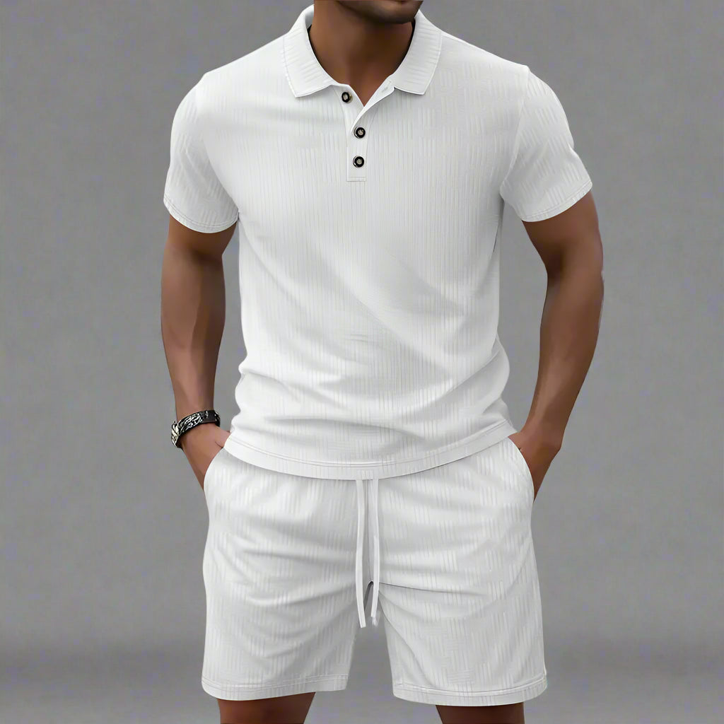 Man wearing a white polo shirt and shorts set on a blurred background