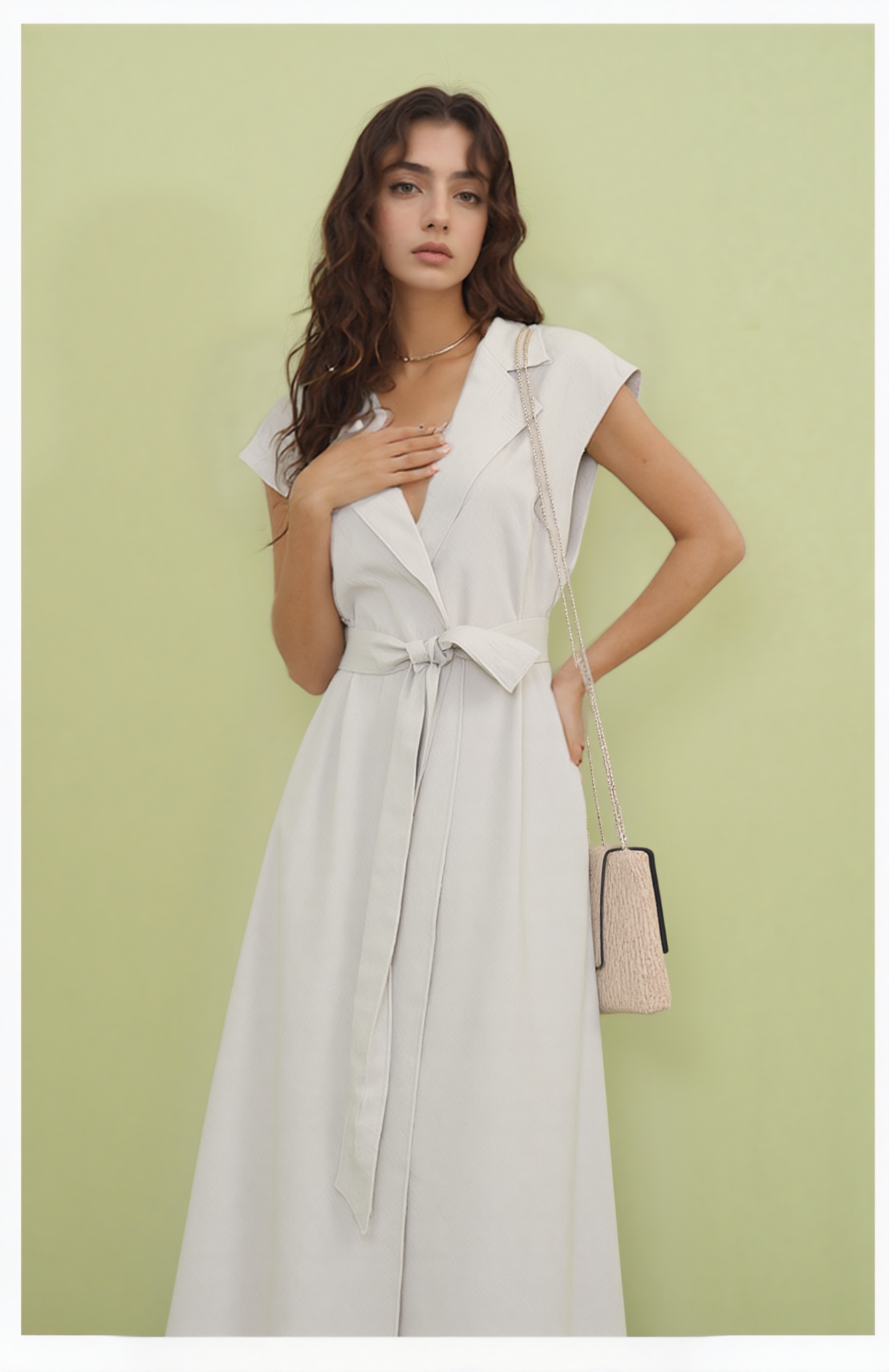 Woman wearing a white dress against a light green background